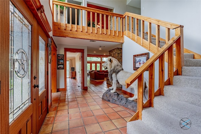 tiled foyer entrance with a high ceiling