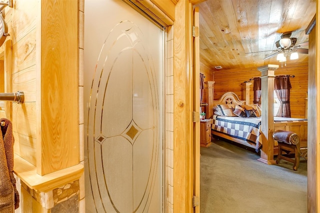 bedroom featuring wooden walls, carpet floors, wooden ceiling, and ceiling fan