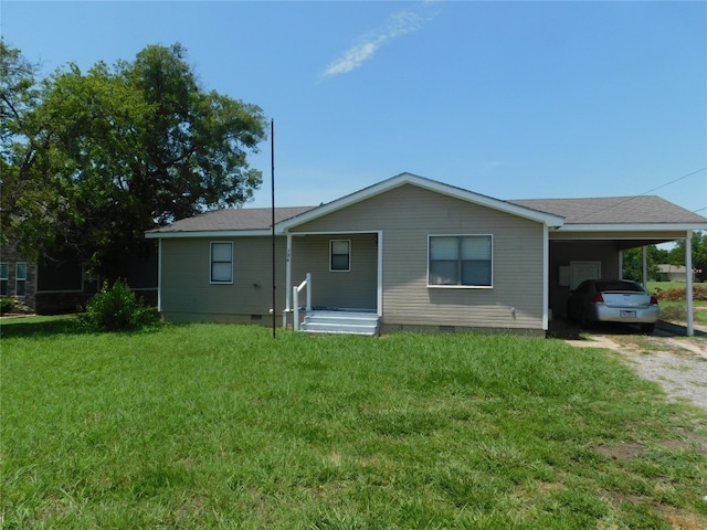 back of house with a yard and a carport