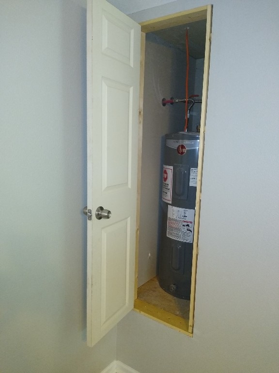 utility room with electric water heater