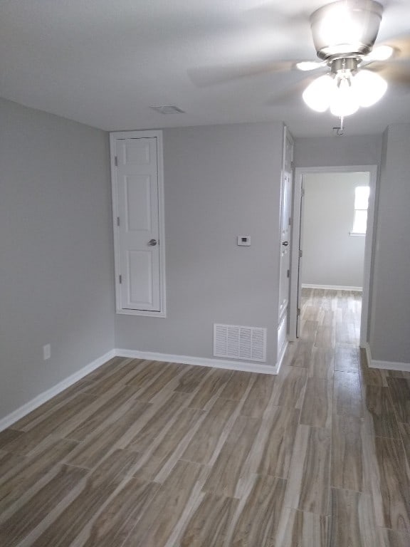 empty room featuring hardwood / wood-style floors and ceiling fan