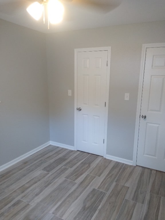 spare room with light hardwood / wood-style flooring and ceiling fan