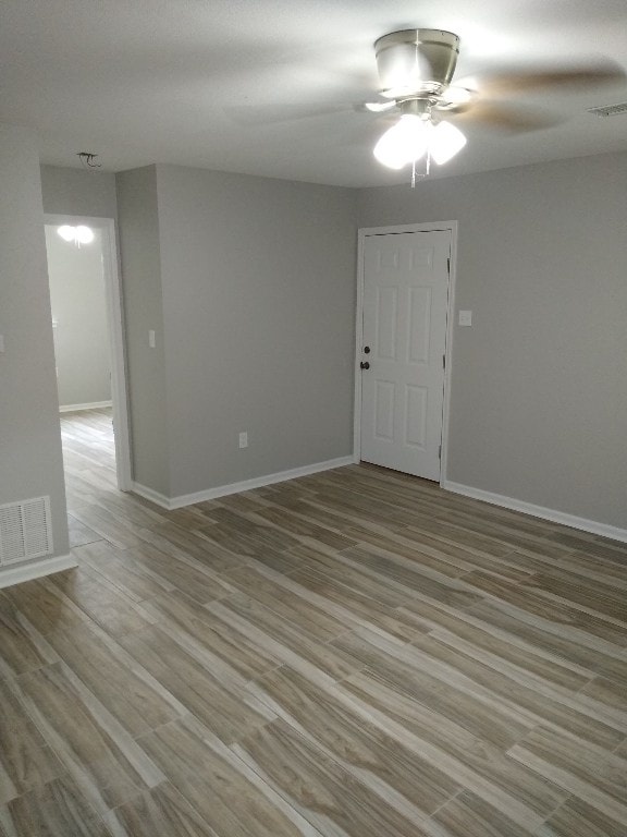 empty room featuring ceiling fan and light wood-type flooring