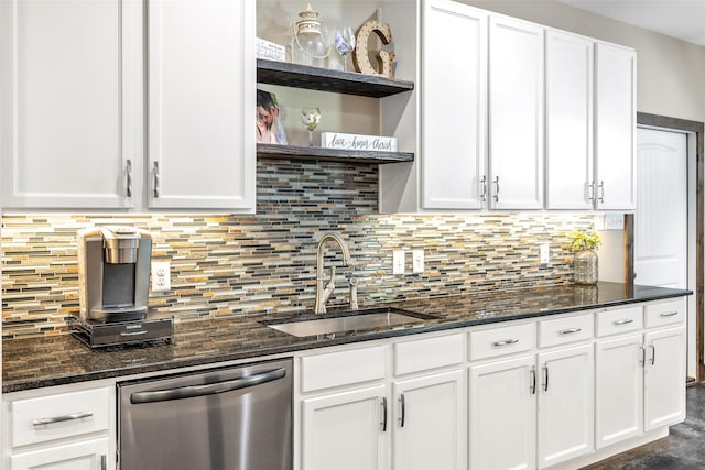 kitchen with stainless steel dishwasher, sink, and white cabinetry