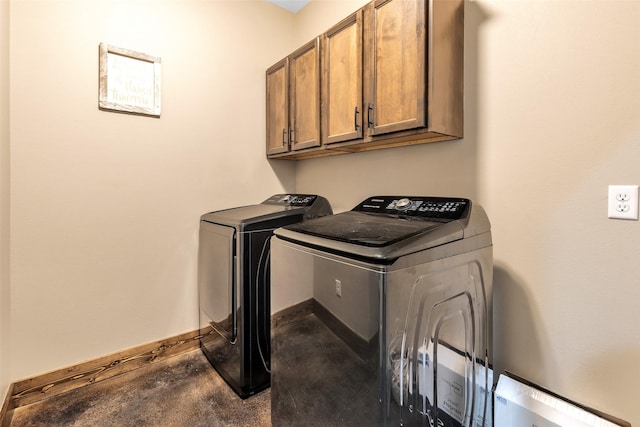 laundry area featuring cabinets and separate washer and dryer