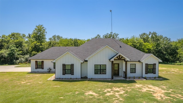 modern inspired farmhouse with a front lawn