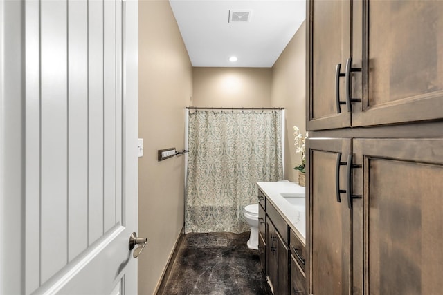 bathroom with tile patterned flooring, vanity, and toilet