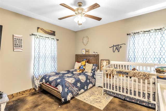 bedroom featuring ceiling fan and carpet