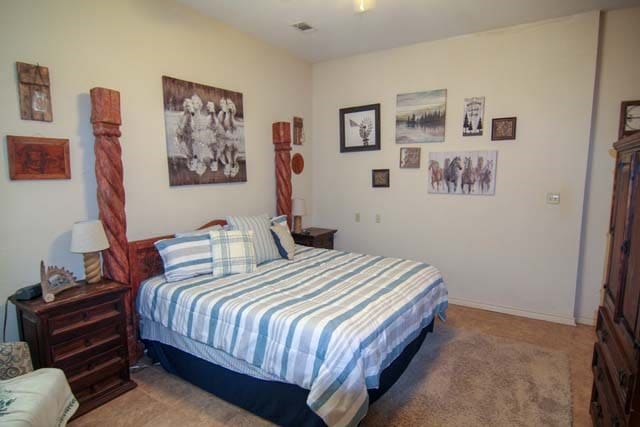 carpeted bedroom featuring a ceiling fan and baseboards