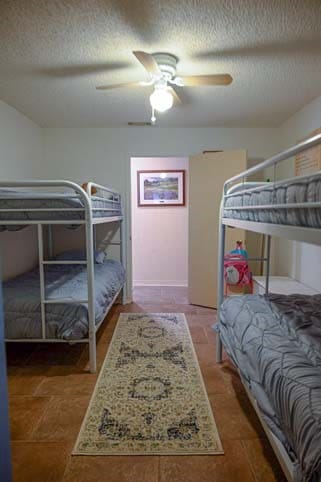 bedroom with ceiling fan and a textured ceiling