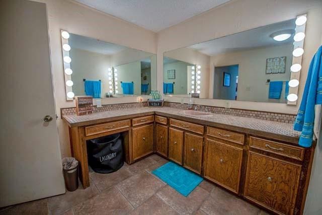 bathroom featuring stone finish flooring and vanity