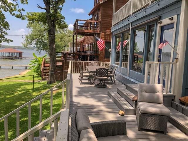 view of patio with a water view and outdoor dining space