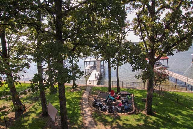 view of yard featuring a water view and fence