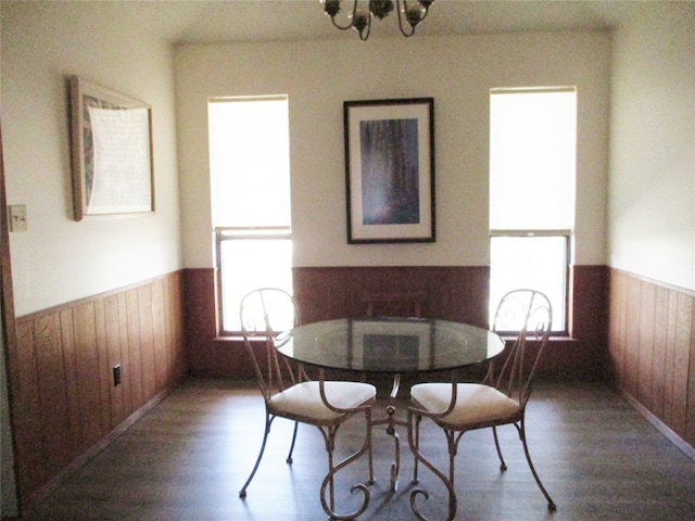 dining room with an inviting chandelier and dark hardwood / wood-style floors