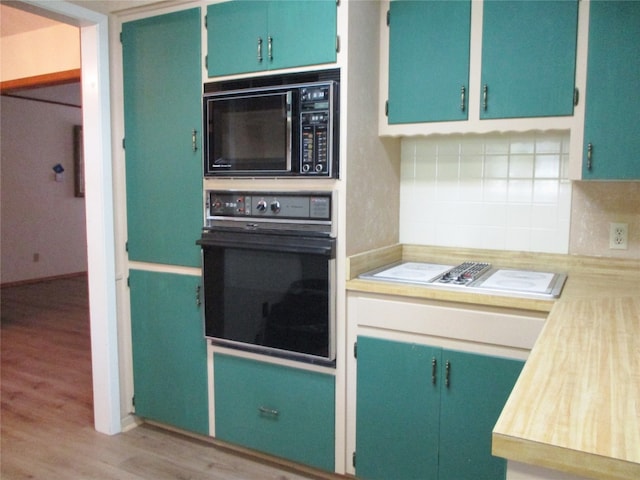 kitchen with tasteful backsplash, light hardwood / wood-style flooring, and black appliances