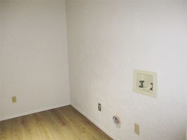 laundry area with light hardwood / wood-style flooring and hookup for a washing machine