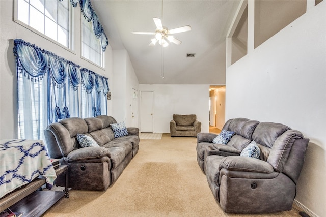 carpeted living room with high vaulted ceiling and ceiling fan