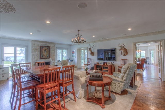 dining area featuring a chandelier and light parquet flooring