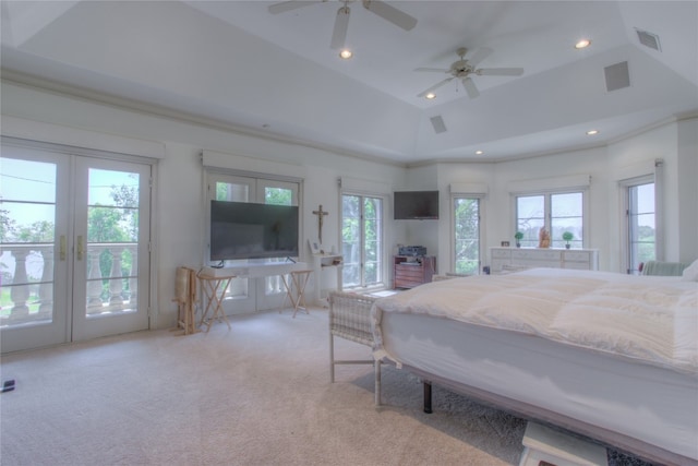 carpeted bedroom with access to outside, a tray ceiling, french doors, and multiple windows