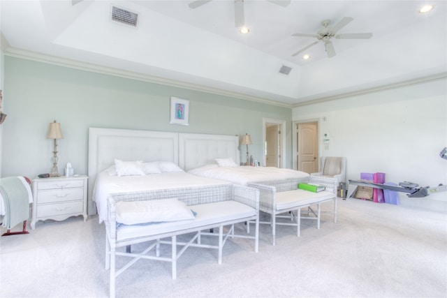 carpeted bedroom featuring ceiling fan, a raised ceiling, and crown molding