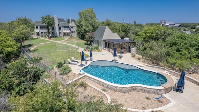 view of pool featuring a patio area and a yard