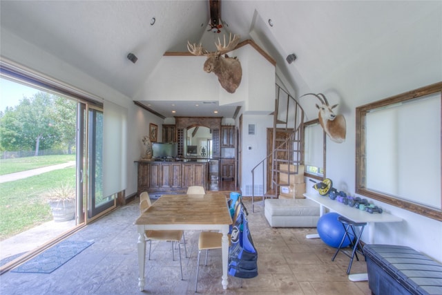 interior space featuring high vaulted ceiling and light tile floors