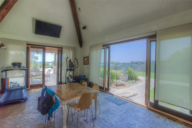 dining room featuring lofted ceiling with beams and tile floors