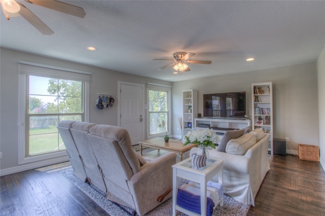 living room with ceiling fan and dark hardwood / wood-style flooring