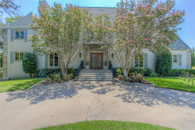 view of front facade featuring a front lawn and french doors