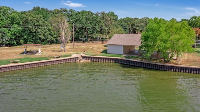 exterior space featuring a water view and a lawn