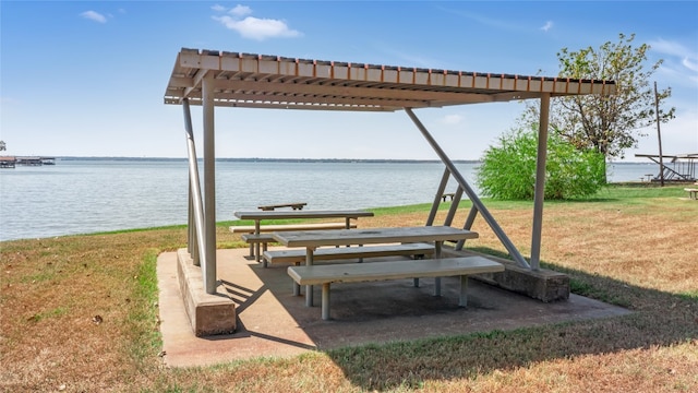 view of home's community featuring a water view, a yard, and a pergola