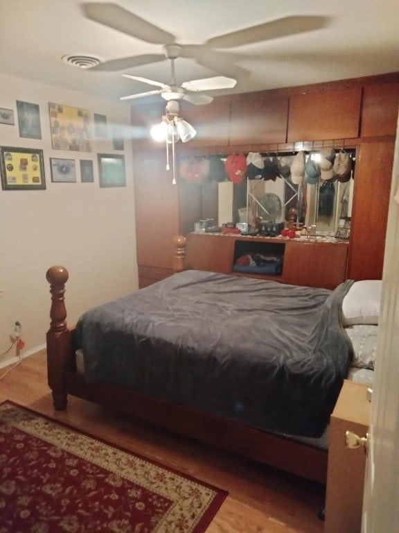 bedroom with ceiling fan and light wood-type flooring