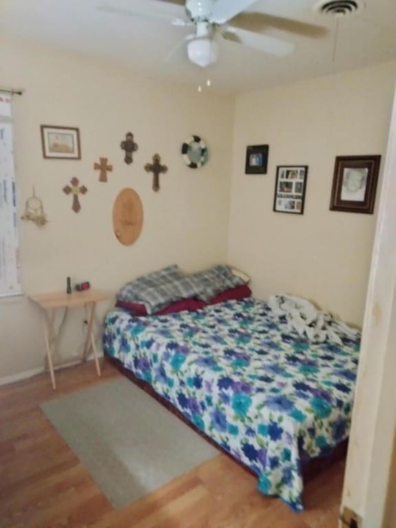 bedroom featuring ceiling fan and hardwood / wood-style flooring