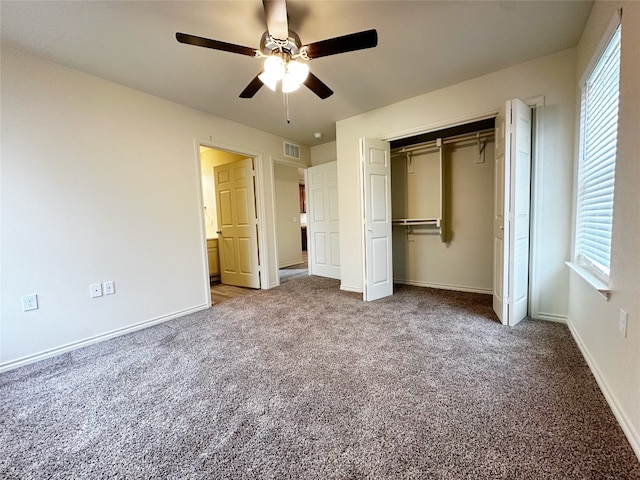 unfurnished bedroom featuring carpet flooring, a closet, ceiling fan, and multiple windows