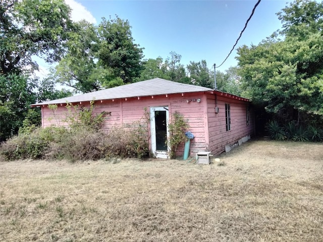 view of side of home featuring a lawn