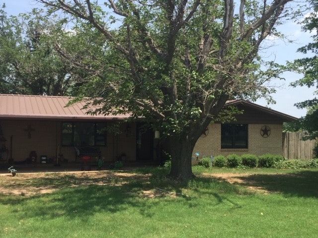 rear view of house with a yard