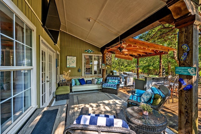 view of patio featuring ceiling fan, french doors, and an outdoor living space