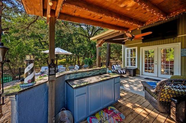 deck featuring ceiling fan and french doors