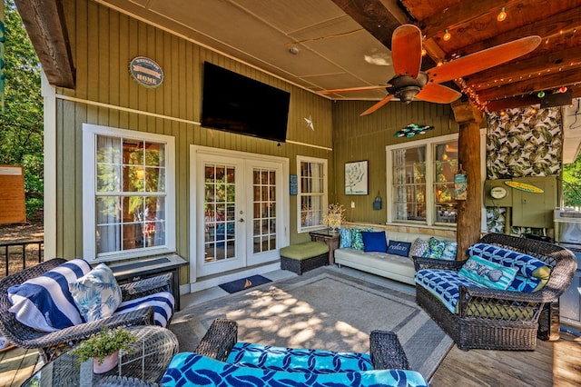 view of patio / terrace with a wooden deck, an outdoor living space, ceiling fan, and french doors