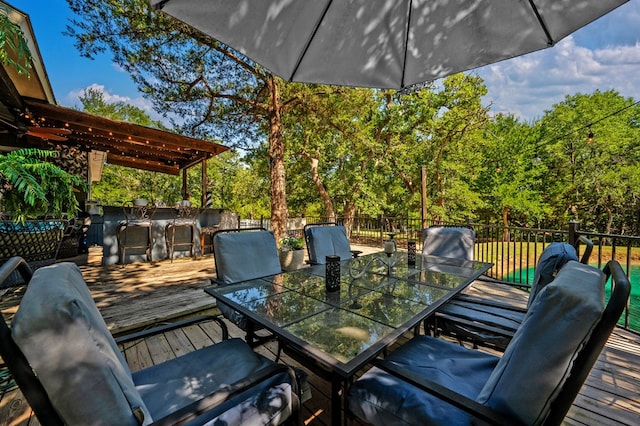 deck with a pergola and an outdoor bar