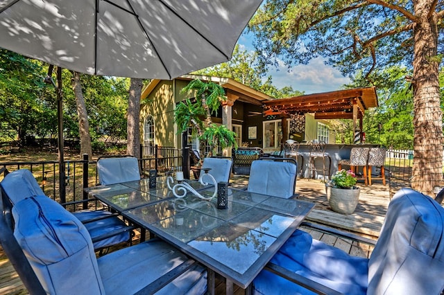 wooden terrace featuring a pergola and an outdoor living space