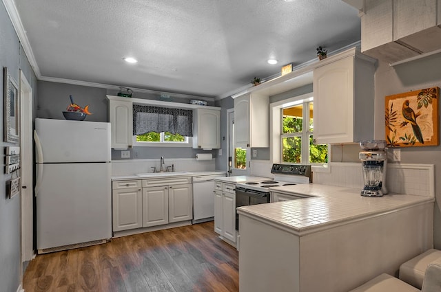 kitchen with dark wood-type flooring, white appliances, white cabinetry, and crown molding