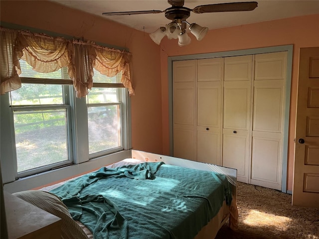 carpeted bedroom with a closet and ceiling fan