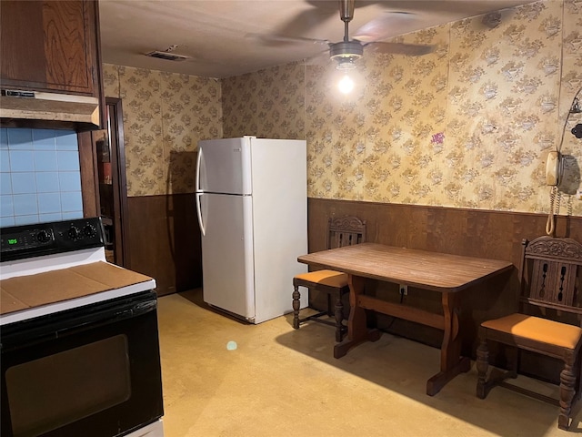 kitchen featuring white fridge, ceiling fan, fume extractor, stove, and light colored carpet