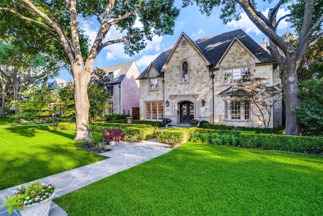 view of front facade with a front lawn and french doors