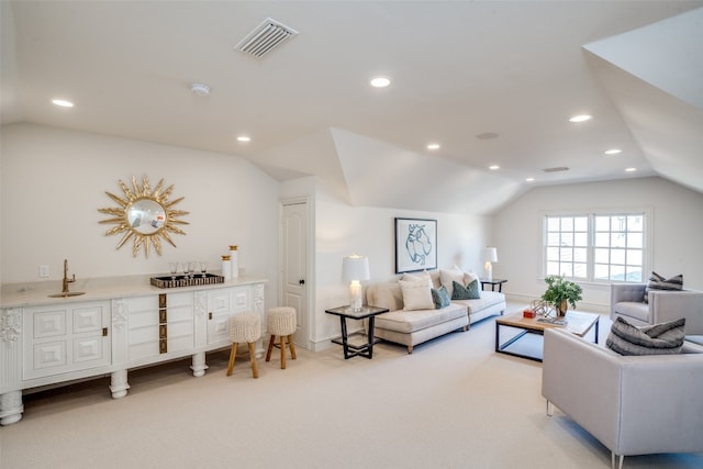 carpeted living room featuring vaulted ceiling