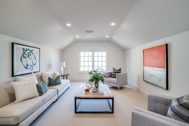 carpeted living room with lofted ceiling