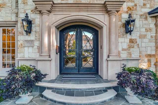 view of exterior entry featuring french doors