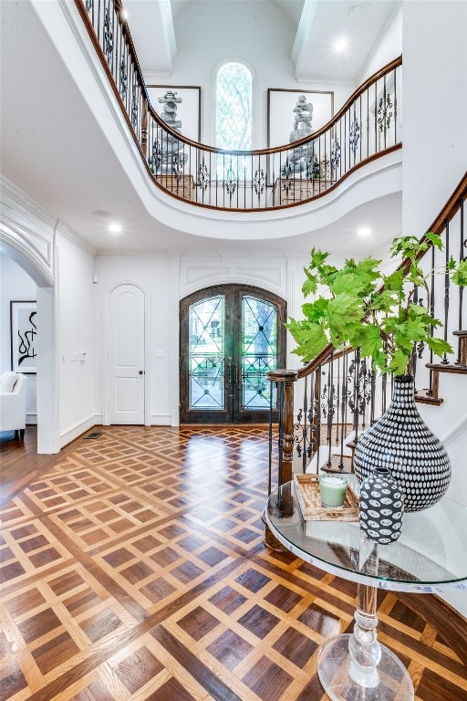 entryway featuring a high ceiling and french doors