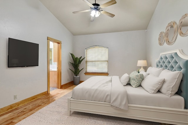 bedroom featuring ceiling fan, lofted ceiling, ensuite bathroom, and light hardwood / wood-style floors